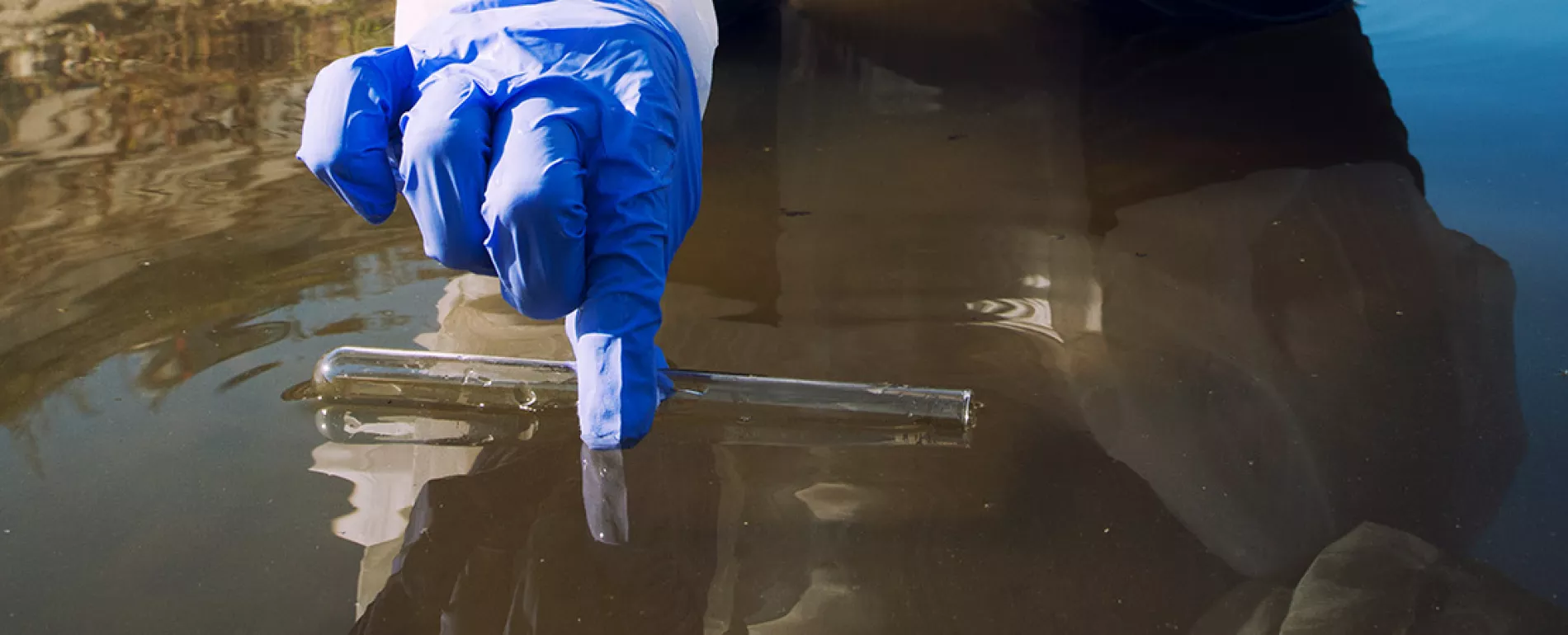 ecologist-taking-samples-water-with-test-tube-from-city-river-determine-level-contamination-pollution